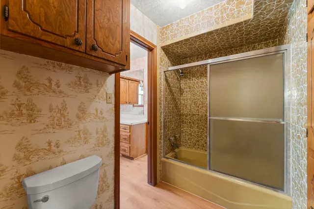 a bathroom with a shower and a toilet