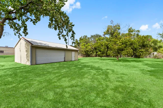 a view of a backyard with large trees