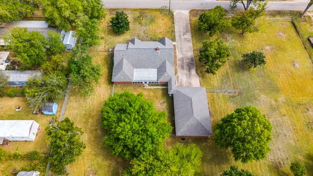 an aerial view of residential houses with outdoor space and swimming pool