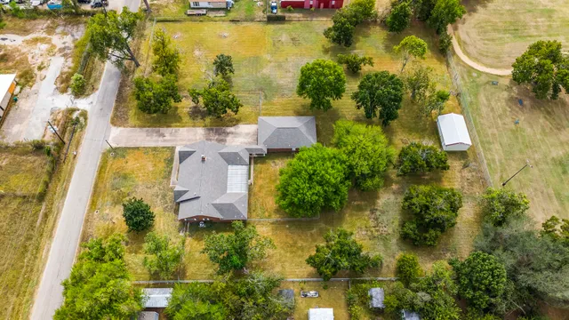 an aerial view of residential houses with yard