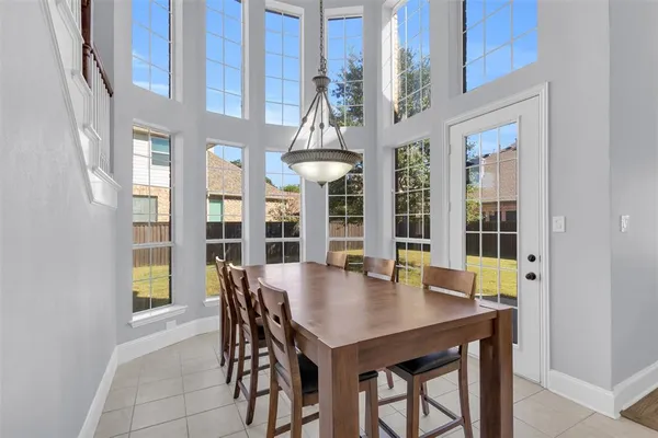 a view of a dining room with furniture and chandelier