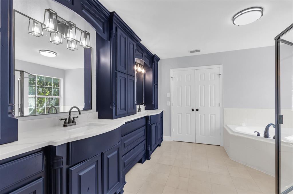 4306 Mitchell Lane Rowlett, TX 75088 - Photo 19 of 39 Bathroom featuring a garden tub, double vanity, a shower stall, and light tile patterned flooring