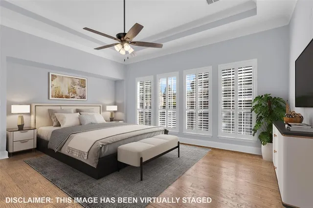 a spacious bedroom with a large bed and a chandelier