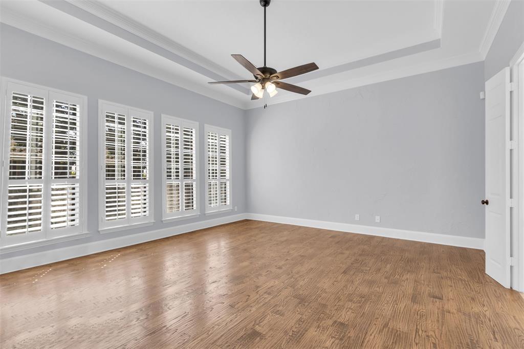 4306 Mitchell Lane Rowlett, TX 75088 - Photo 23 of 39 Unfurnished room featuring a raised ceiling, ornamental molding, wood finished floors, and a ceiling fan