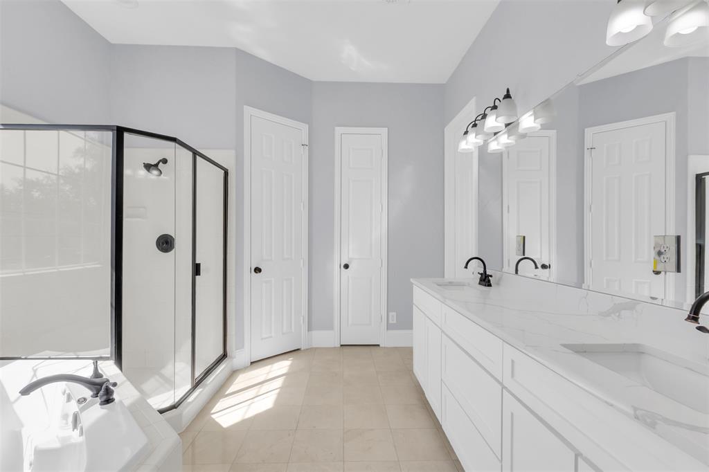 4306 Mitchell Lane Rowlett, TX 75088 - Photo 25 of 39 Full bath featuring light tile patterned floors, double vanity, a bath, and a shower stall