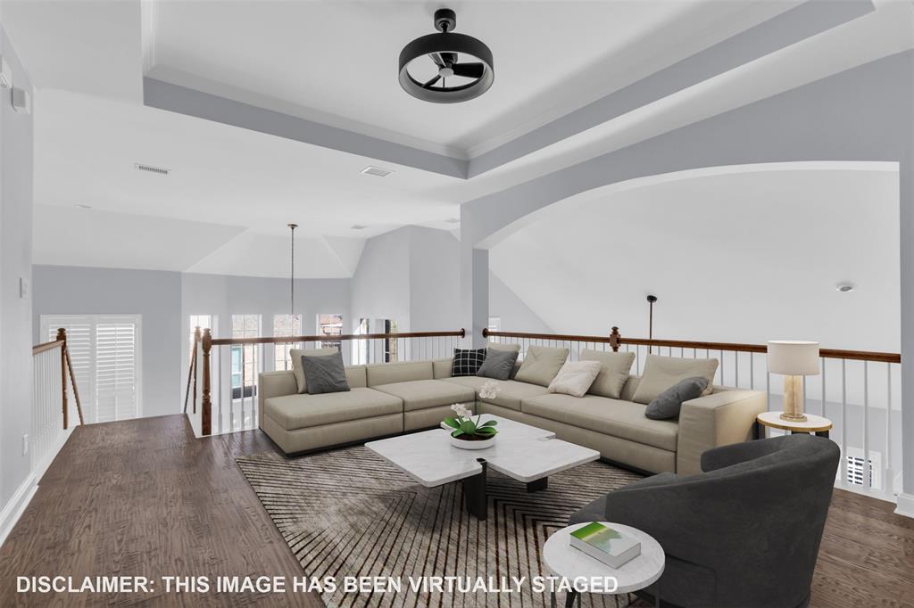 4306 Mitchell Lane Rowlett, TX 75088 - Photo 27 of 39 Living area with a raised ceiling and dark wood-type flooring