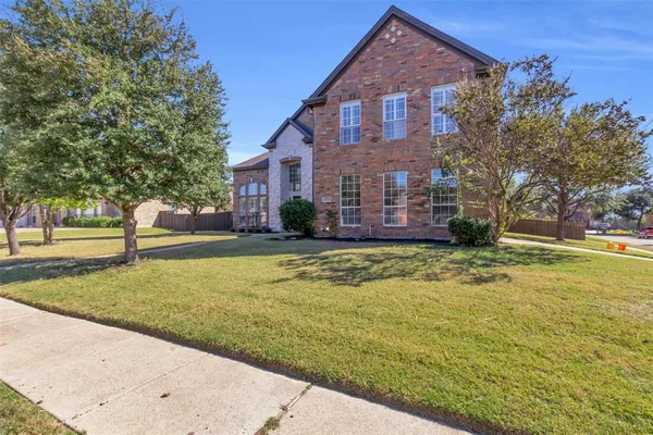 a front view of a house with a yard