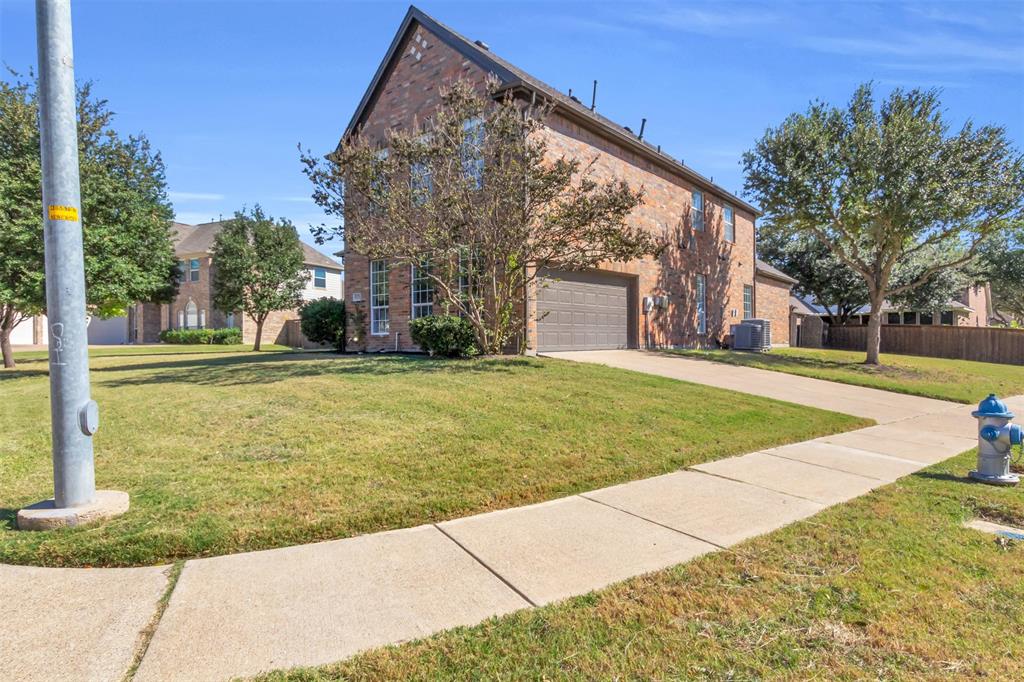 4306 Mitchell Lane Rowlett, TX 75088 - Photo 5 of 39 View of property hidden behind natural elements with brick siding and driveway