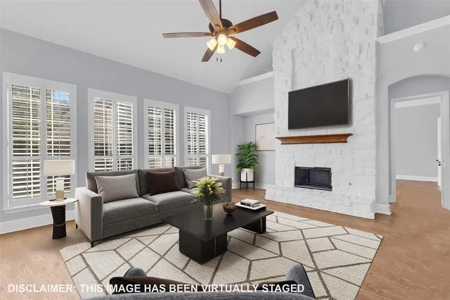 a living room with furniture a fireplace and a flat screen tv