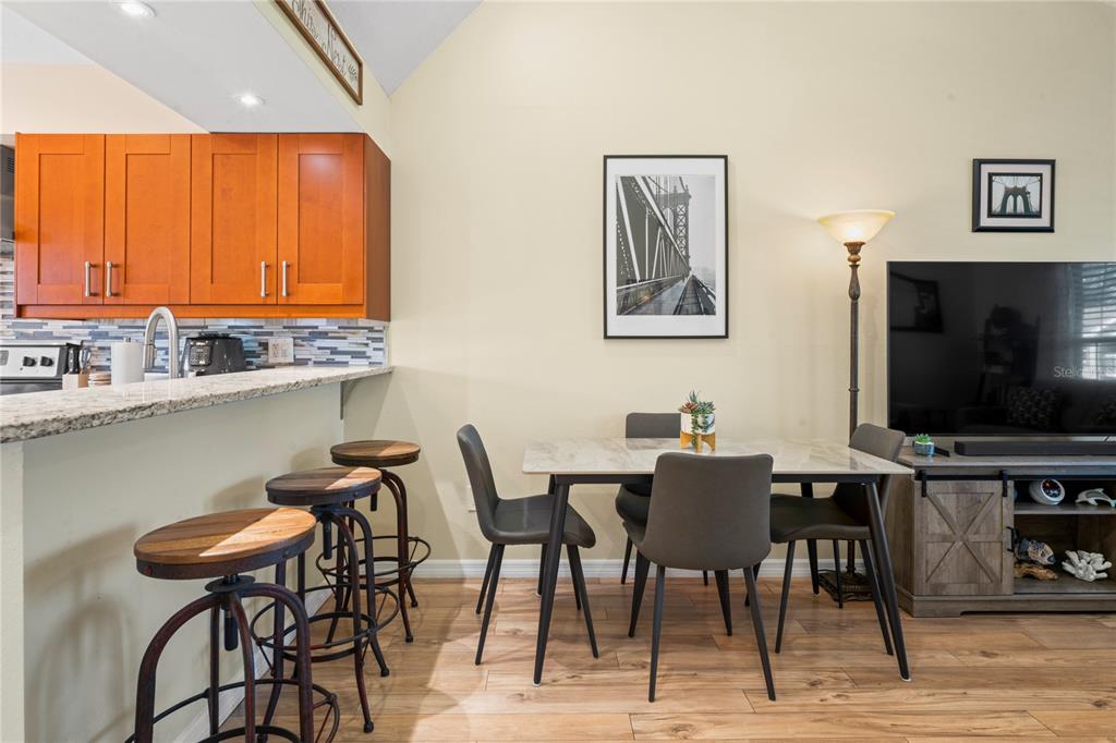 6424 Spring Flower Drive, Unit 24 New Port Richey, FL 34653 - Photo 14 of 66 a view of a dining room with furniture and a flat screen tv