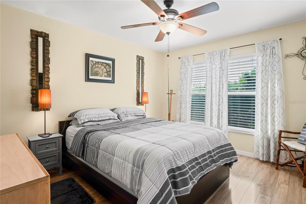 6424 Spring Flower Drive, Unit 24 New Port Richey, FL 34653 - Photo 15 of 66 a bedroom with a bed a dresser and a large mirror