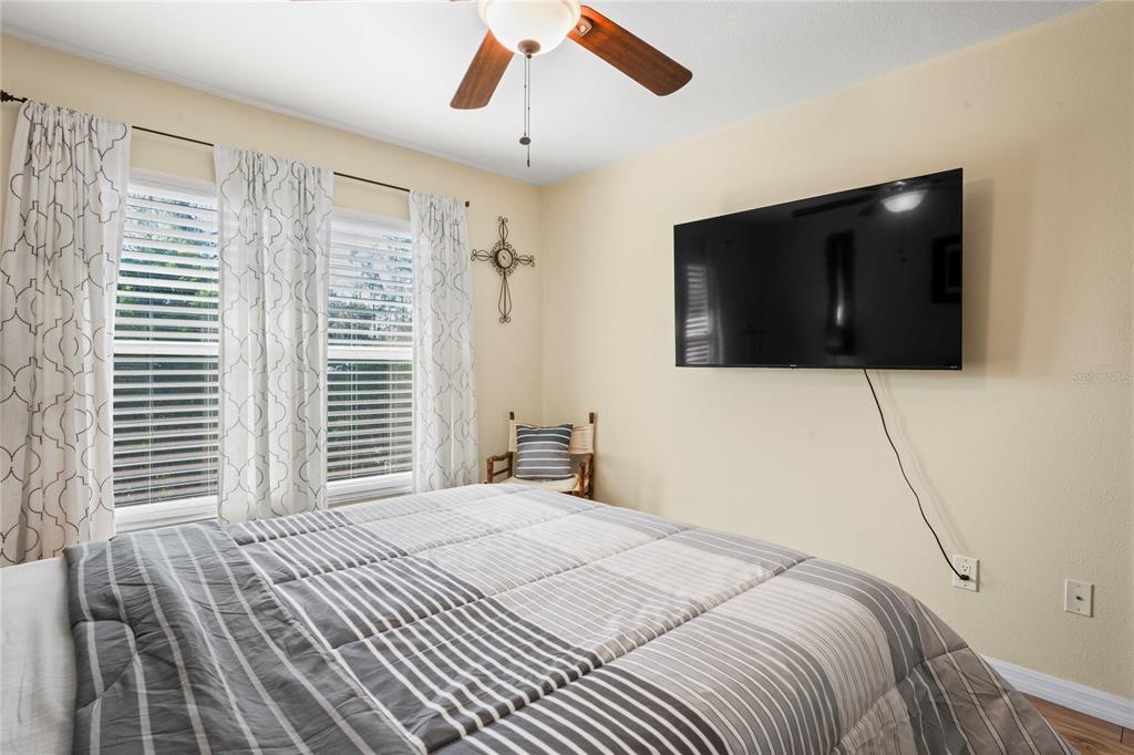 6424 Spring Flower Drive, Unit 24 New Port Richey, FL 34653 - Photo 17 of 66 a bedroom with a bed and a television