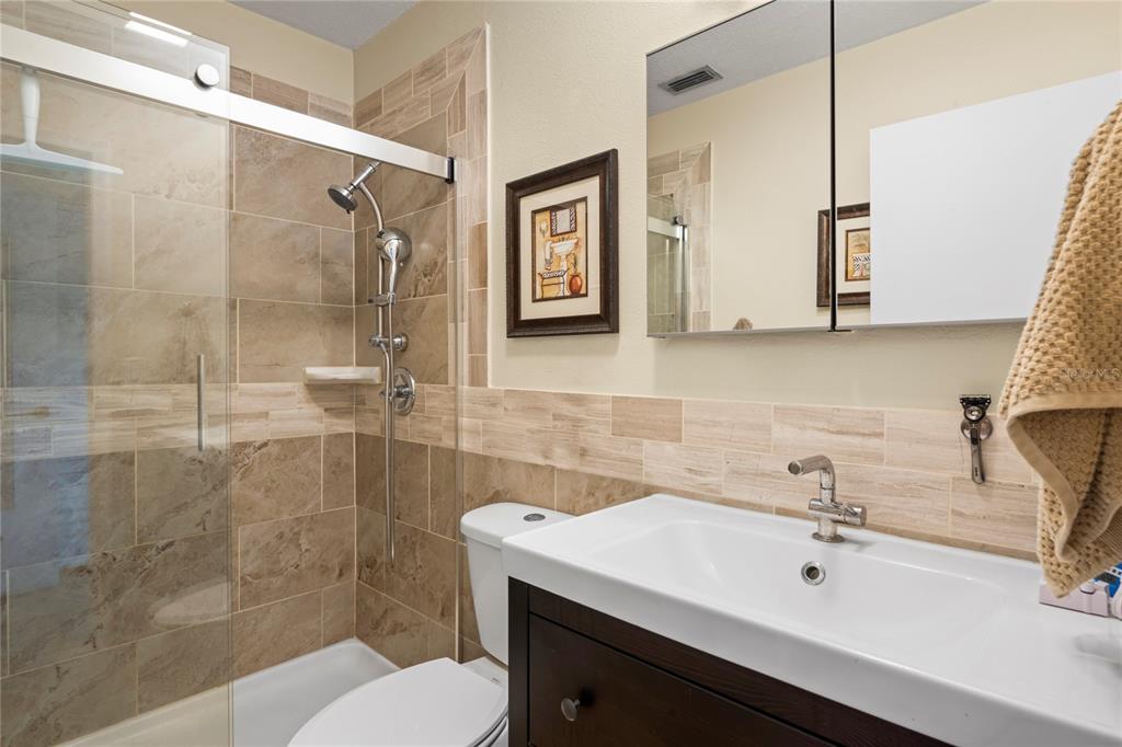 6424 Spring Flower Drive, Unit 24 New Port Richey, FL 34653 - Photo 19 of 66 a bathroom with a sink toilet and shower