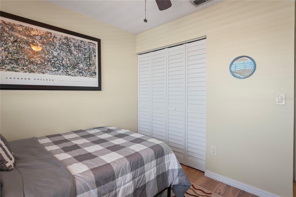 6424 Spring Flower Drive, Unit 24 New Port Richey, FL 34653 - Photo 23 of 66 a bedroom with a bed and a wall painting