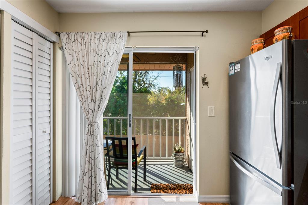 6424 Spring Flower Drive, Unit 24 New Port Richey, FL 34653 - Photo 26 of 66 a view of a hallway with wooden floor and a refrigerator