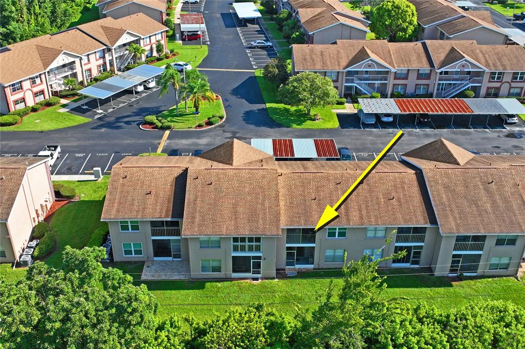 6424 Spring Flower Drive, Unit 24 New Port Richey, FL 34653 - Photo 29 of 66 an aerial view of multiple houses with a yard