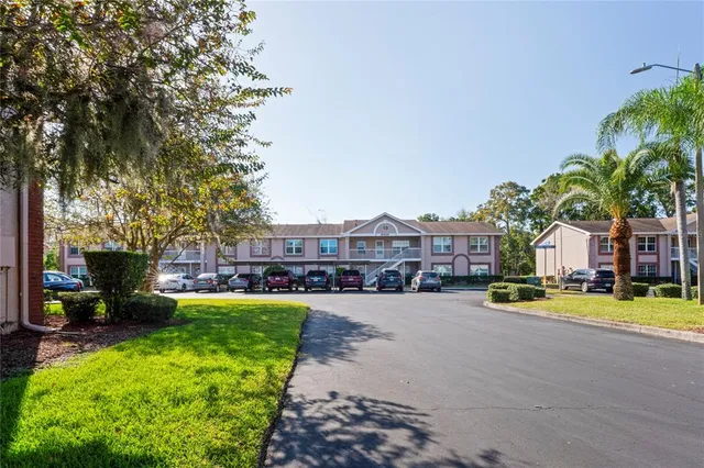 an aerial view of a house with swimming pool and a yard