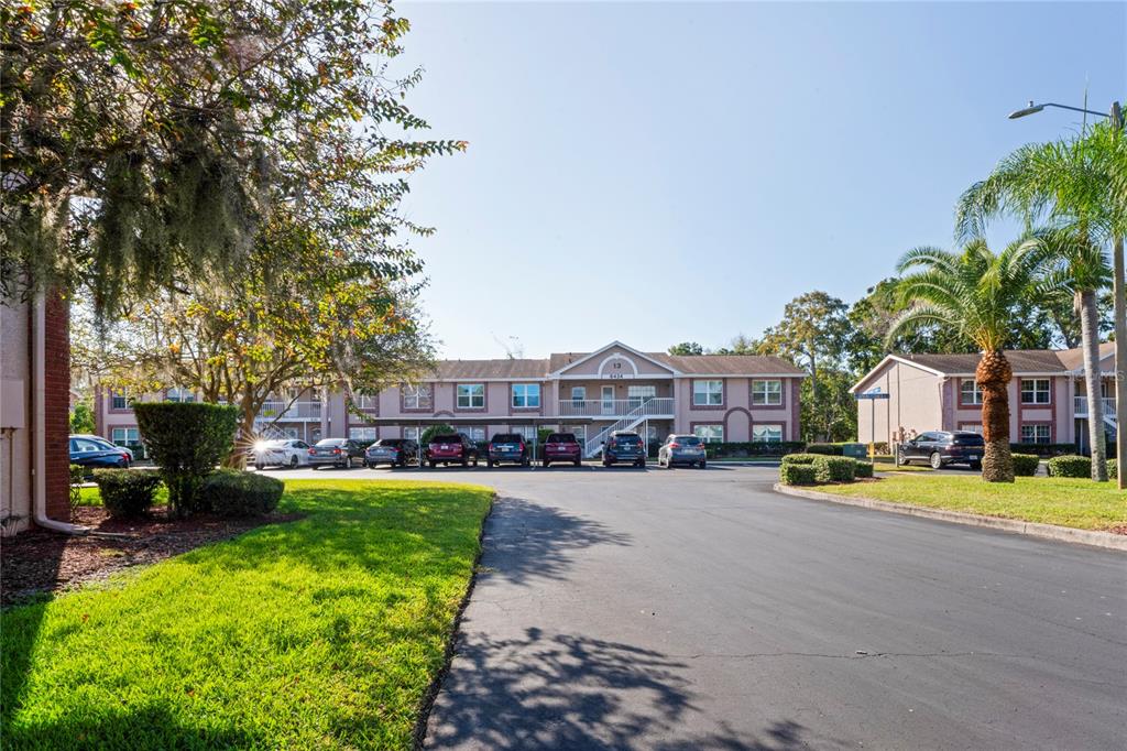 6424 Spring Flower Drive, Unit 24 New Port Richey, FL 34653 - Photo 32 of 66 a view of a swimming pool with lawn chairs and a yard