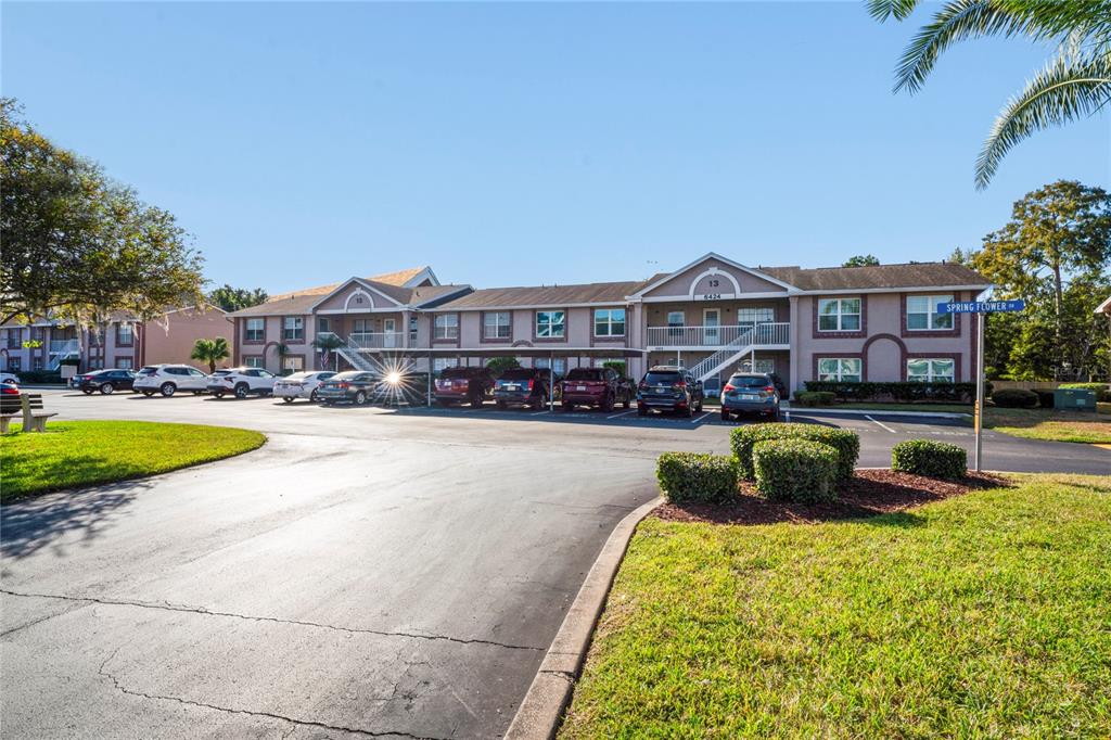 6424 Spring Flower Drive, Unit 24 New Port Richey, FL 34653 - Photo 33 of 66 a swimming pool view with a seating space and a garden view