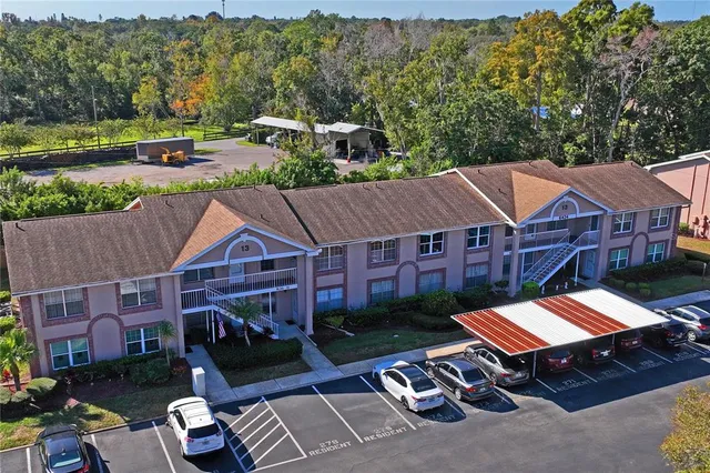 an aerial view of a house with a garden and lake view