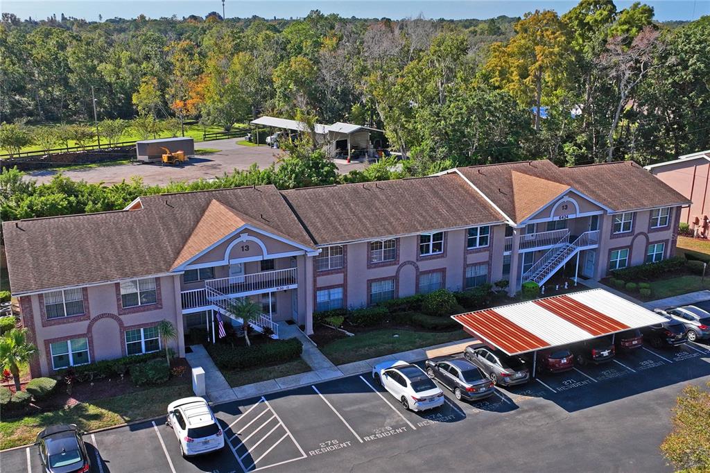 6424 Spring Flower Drive, Unit 24 New Port Richey, FL 34653 - Photo 41 of 66 an aerial view of a house with swimming pool and a yard