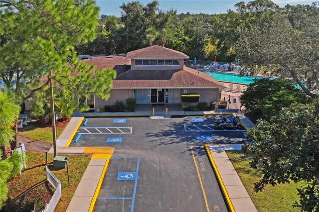 an aerial view of a house with a yard basket ball court and outdoor seating