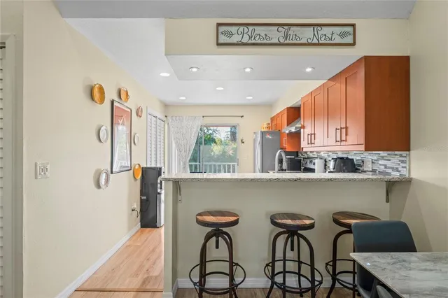 a kitchen with stainless steel appliances granite countertop a stove a sink and a refrigerator