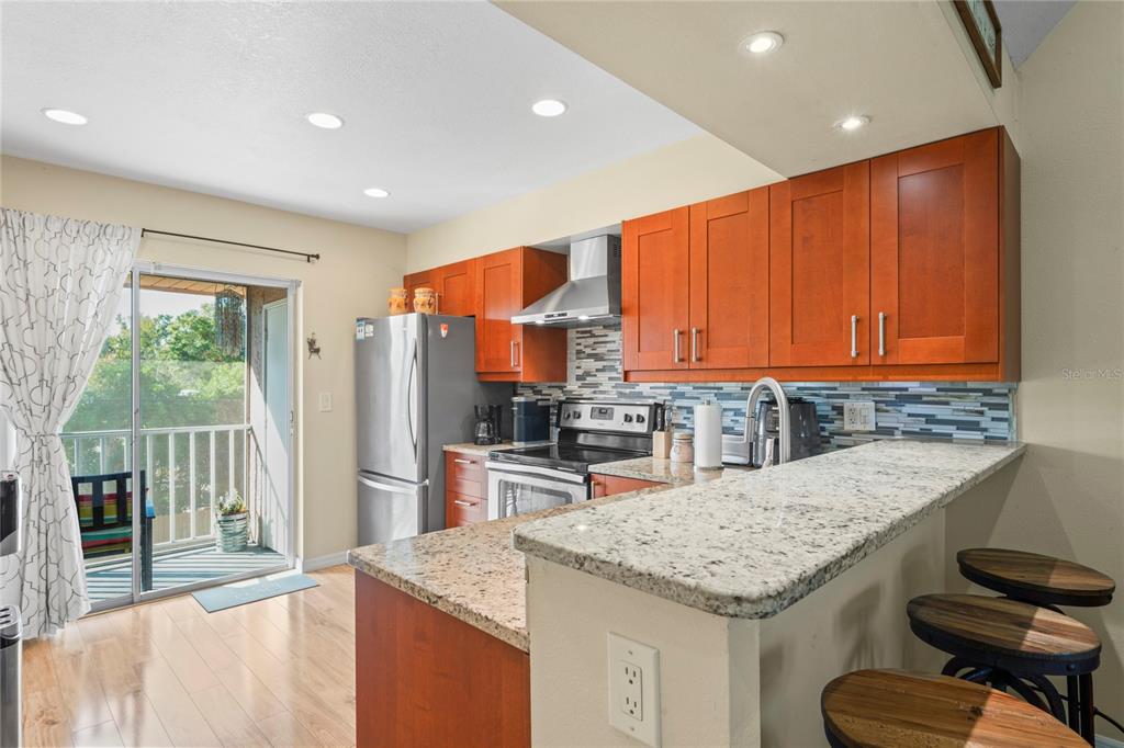 6424 Spring Flower Drive, Unit 24 New Port Richey, FL 34653 - Photo 9 of 66 a kitchen with stainless steel appliances granite countertop a sink and cabinets