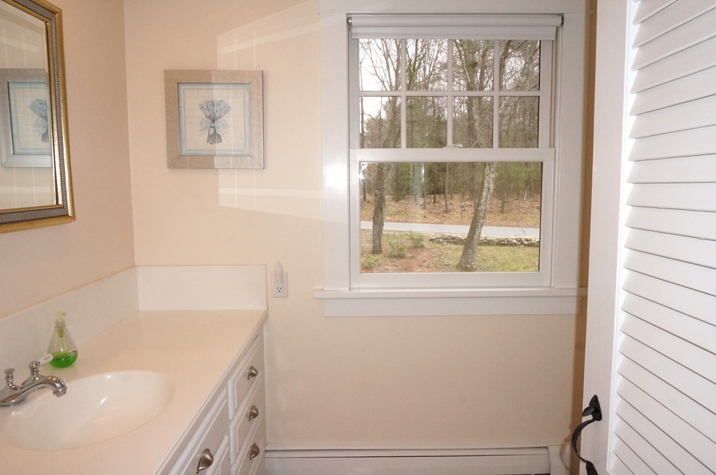 18 Jacob Gates Road Harvard, MA 01451 - Photo 17 of 26 a bathroom with a tub a sink and a window