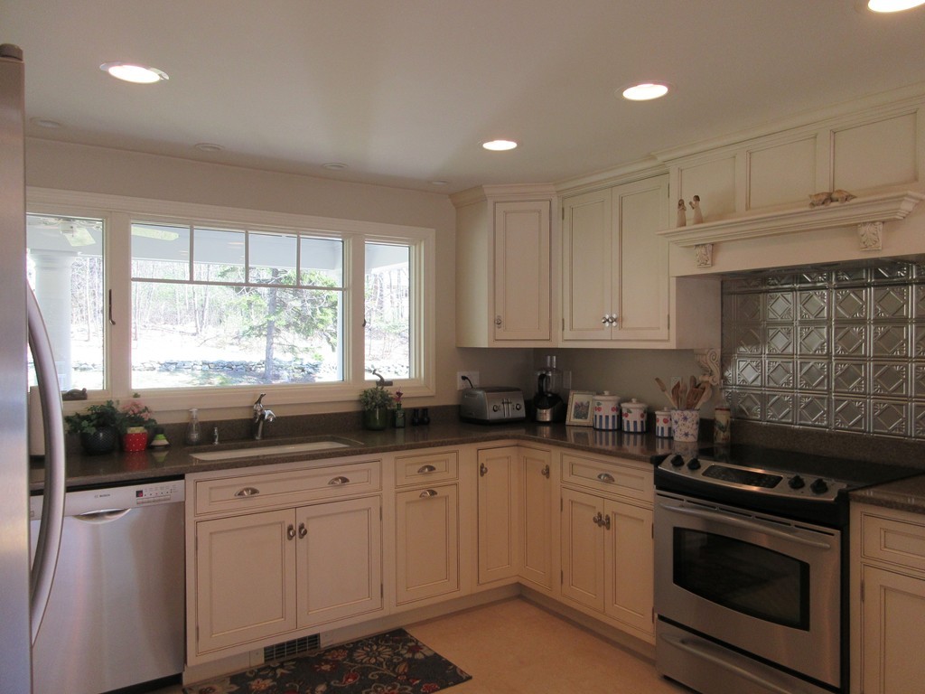 18 Jacob Gates Road Harvard, MA 01451 - Photo 5 of 26 a kitchen with granite countertop white cabinets and white appliances
