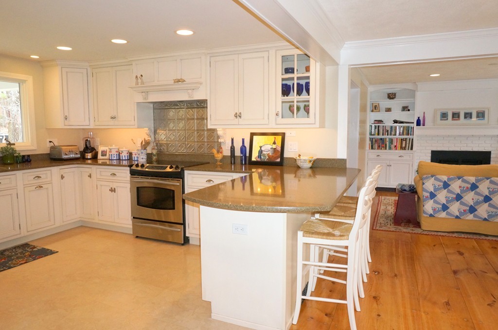 18 Jacob Gates Road Harvard, MA 01451 - Photo 8 of 26 a kitchen with granite countertop a sink a stove and cabinets