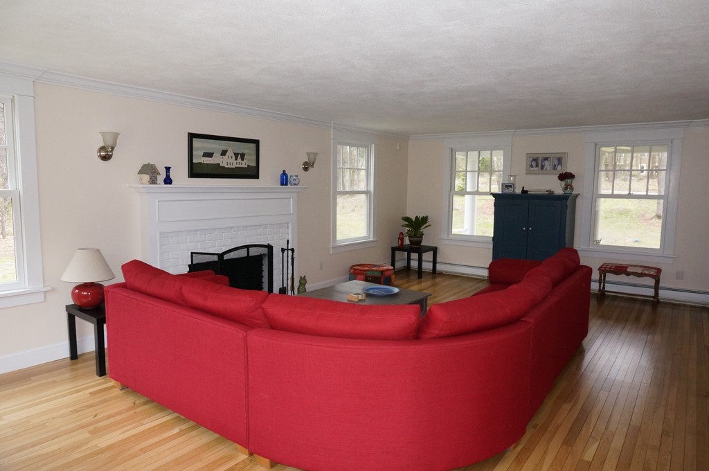 18 Jacob Gates Road Harvard, MA 01451 - Photo 10 of 26 a living room with furniture and a fireplace