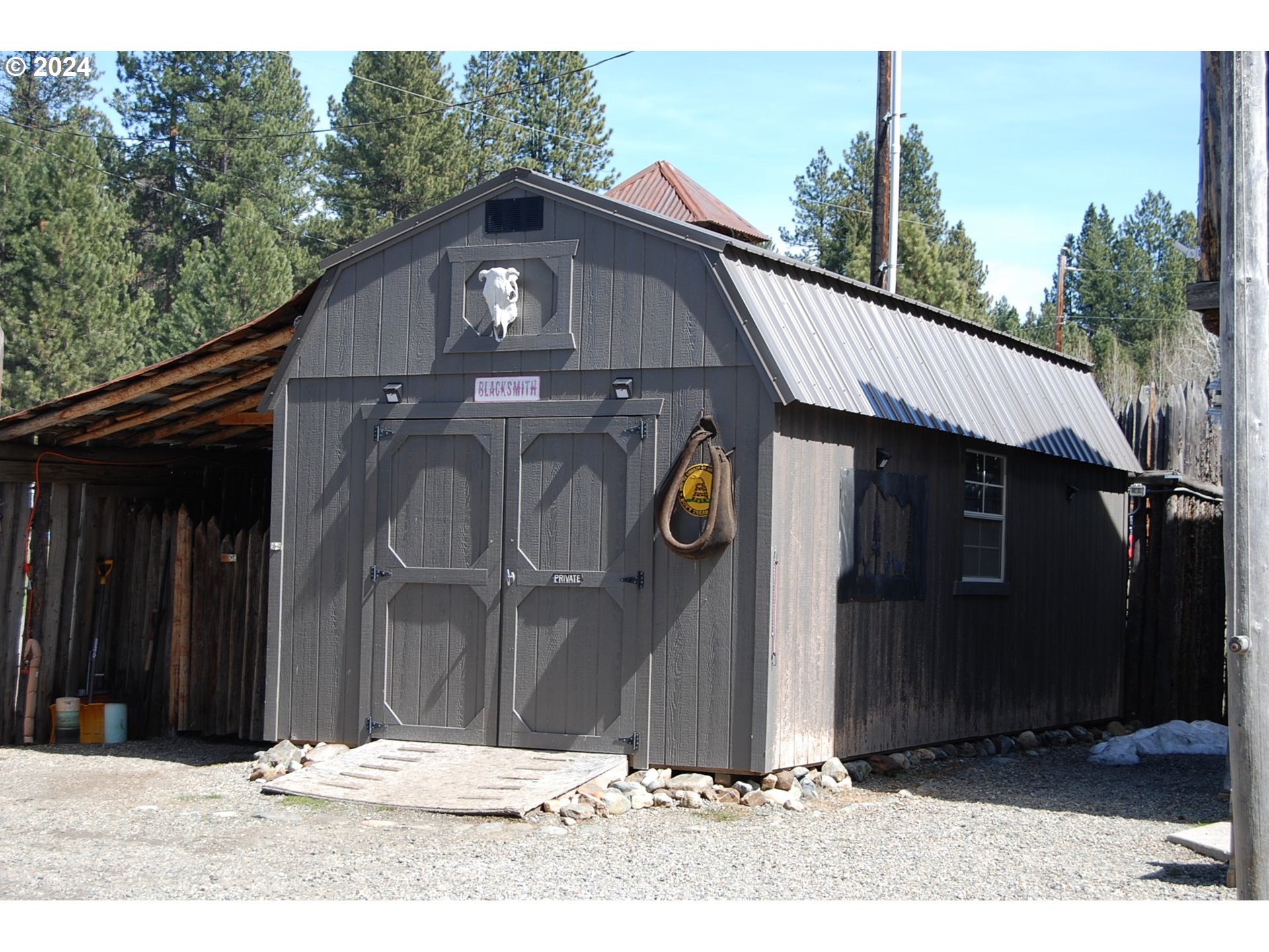 129 Austin Street Sumpter, OR 97877 - Photo 12 of 34 a black and white building with trees in the background