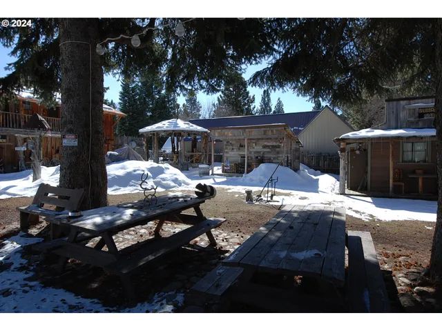a view of a house with a yard covered in snow