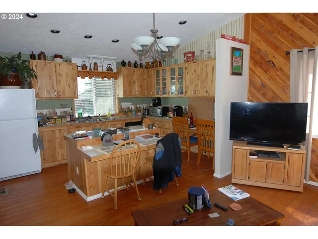 a dining room with furniture a chandelier and a window