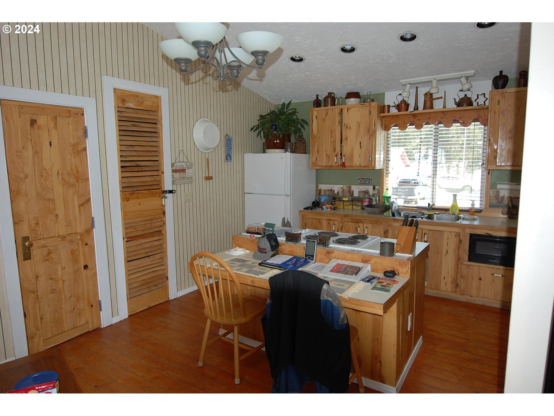 129 Austin Street Sumpter, OR 97877 - Photo 25 of 34 a dining room with furniture a chandelier and a window