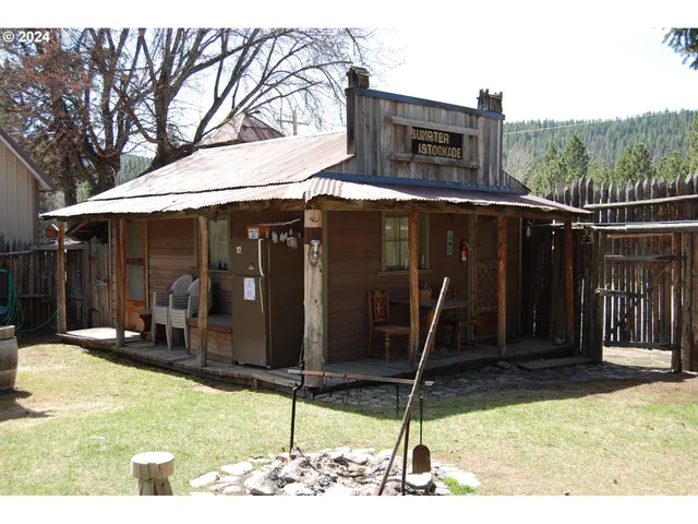 a backyard of a house with barbeque oven