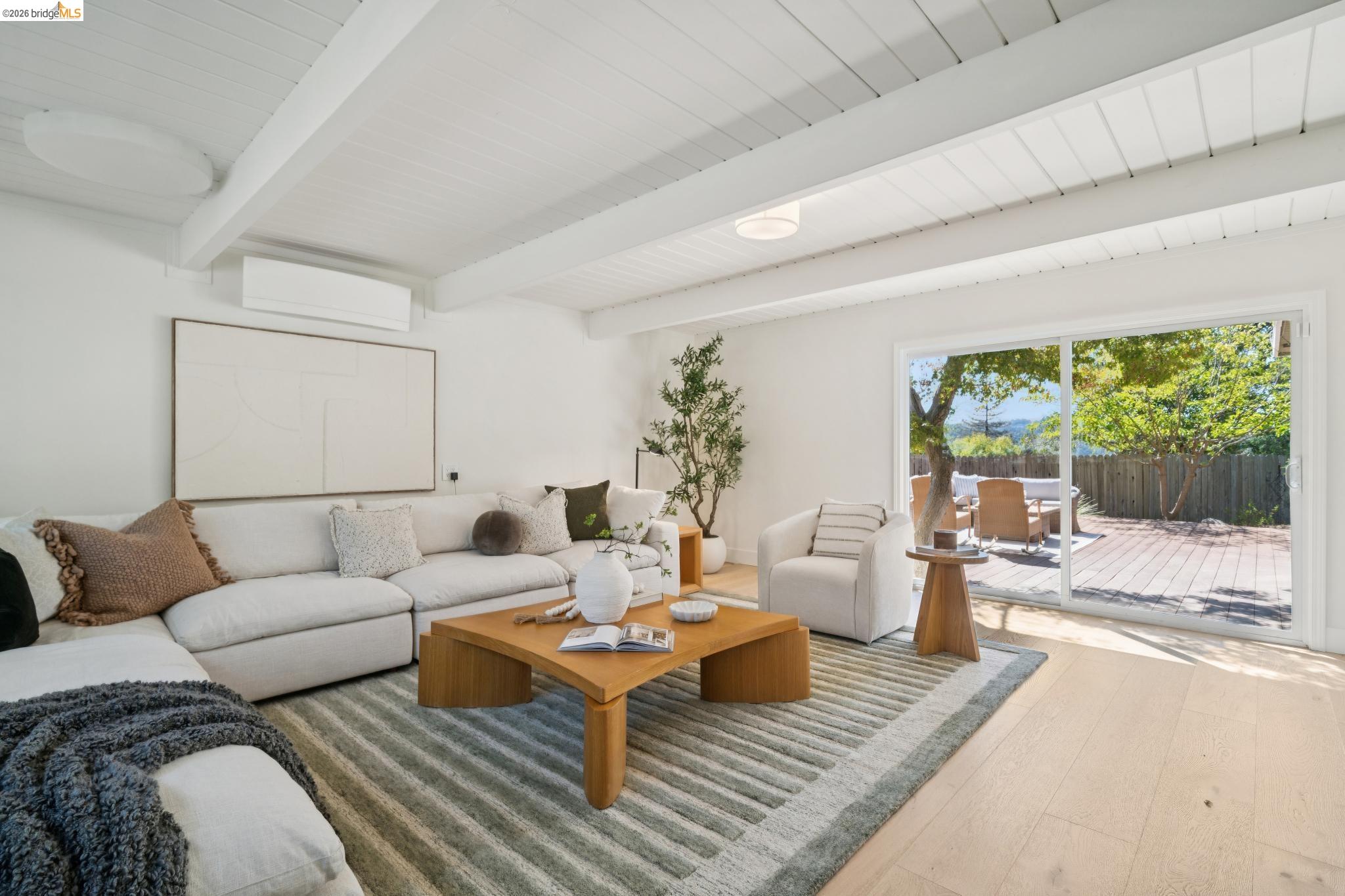 1321 Sunset Loop Lafayette, CA 94549 - Photo 15 of 49 Whitewashed exposed beam ceiling, recessed lighting, light wood-finish flooring, sliding glass door, and a spacious outdoor deck