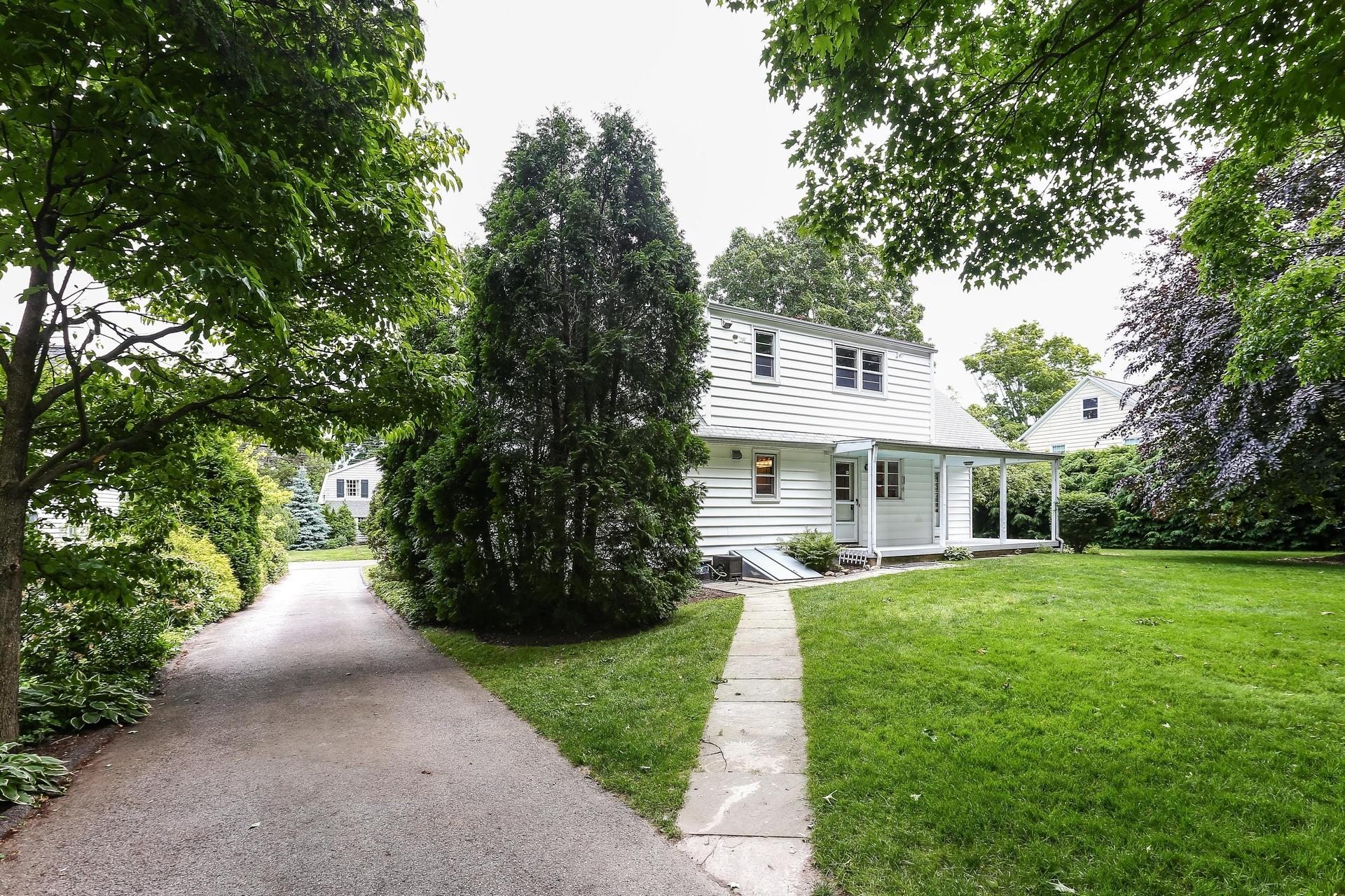 35 Dickinson Road Darien, CT 06820 - Photo 23 of 30 a front view of a house with a garden and trees