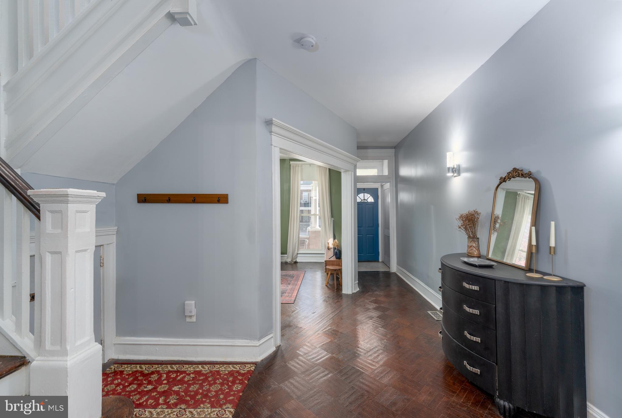 2512 Brookfield Avenue Baltimore, MD 21217 - Photo 8 of 35 a view of a hallway to a livingroom with wooden floor and furniture