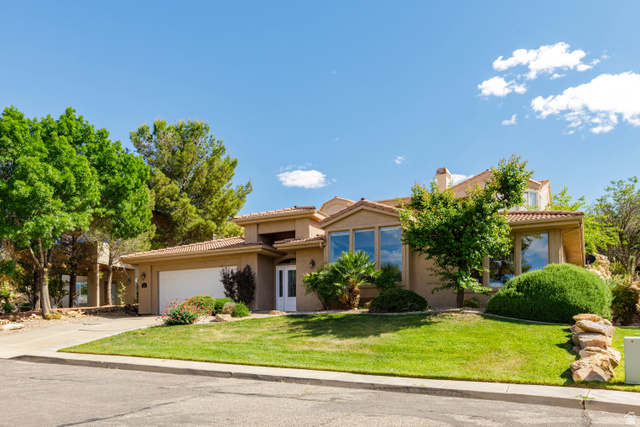2158 Balboa Way St. George, UT 84770 - Photo 2 of 40 Stucco exterior residence featuring a tile roof, an attached garage, and multiple large windows