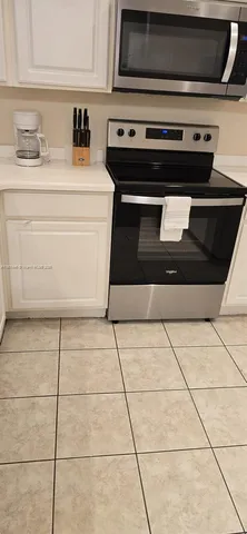 a stove top oven sitting inside of a kitchen