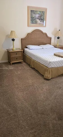 a bedroom with a bed and lamp