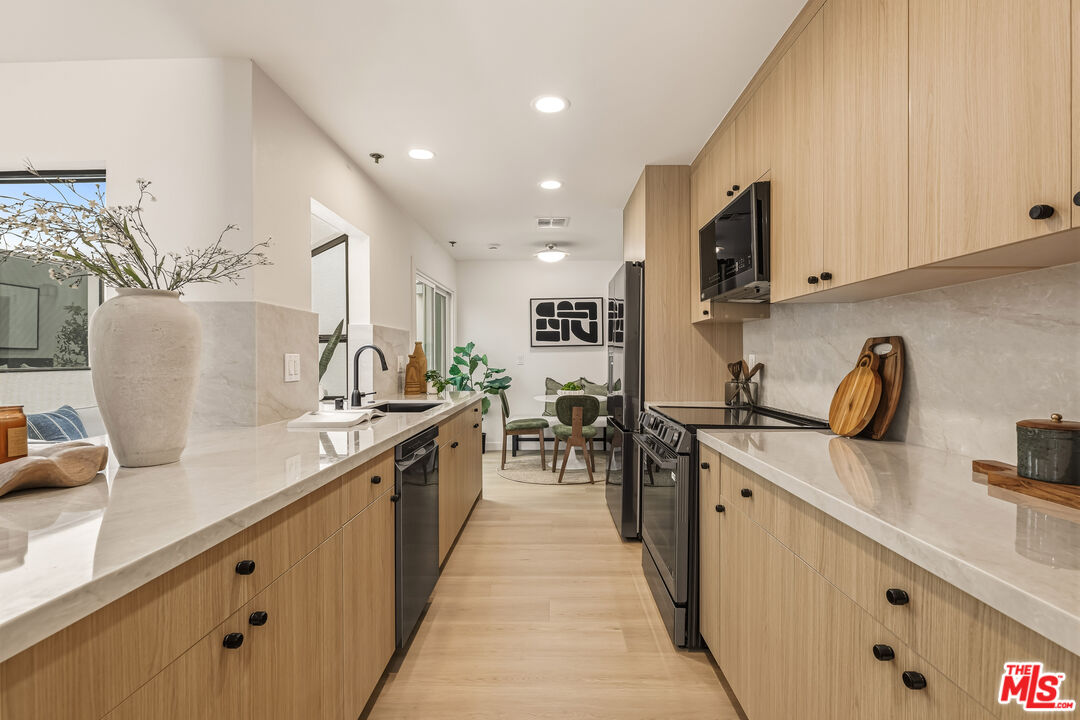 311 Bora Bora Way, Unit 3207 Marina del Rey, CA 90292 - Photo 1 of 54 a kitchen with stainless steel appliances granite countertop a sink counter space and a stove
