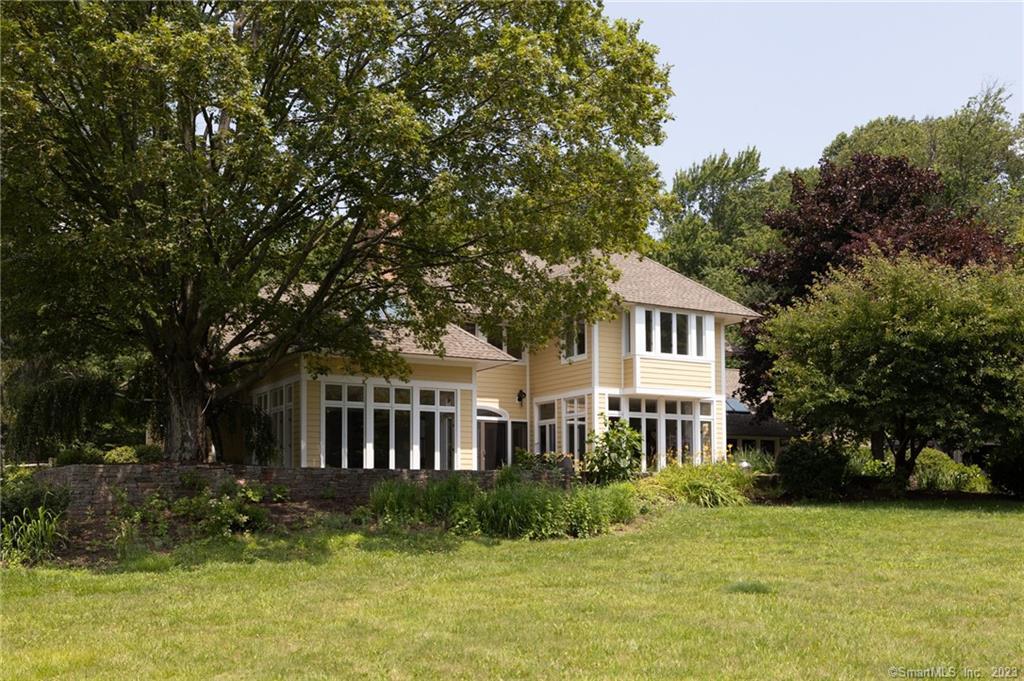 274 Westledge Road Simsbury, CT 06092 - Photo 1 of 1 a front view of a house with a yard table and chairs