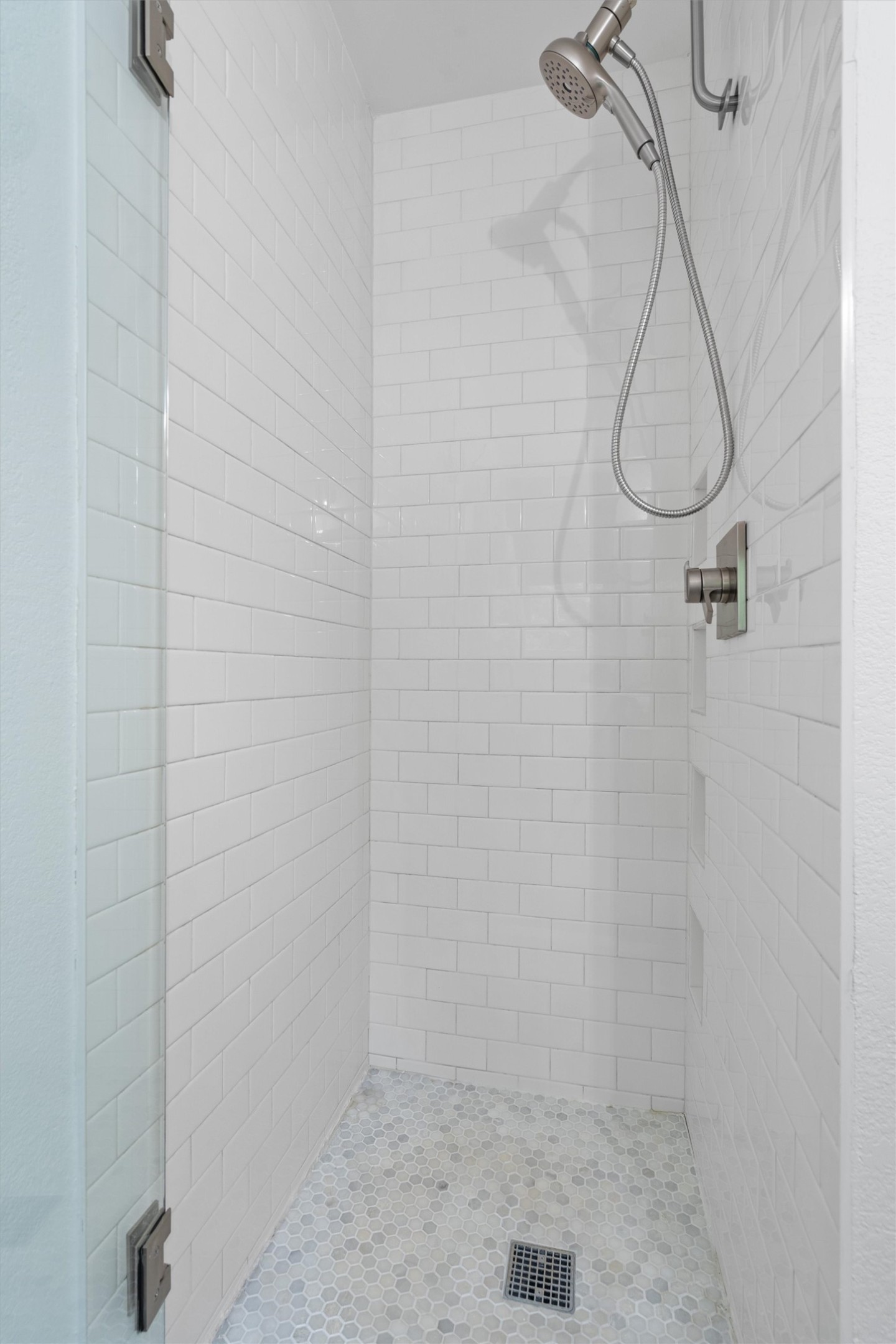 8436 Bangor Bend Austin, TX 78758 - Photo 17 of 29 The ensuite also features a walk-in shower, with floor to ceiling subway tile surround, enclosed by frameless glass.