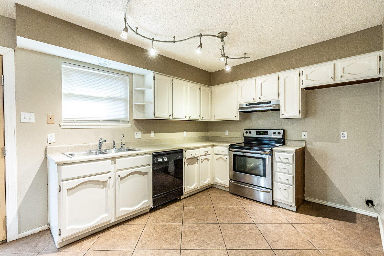 4737 48th Street Lubbock, TX 79414 - Photo 13 of 34 a kitchen with stainless steel appliances granite countertop a sink and cabinets
