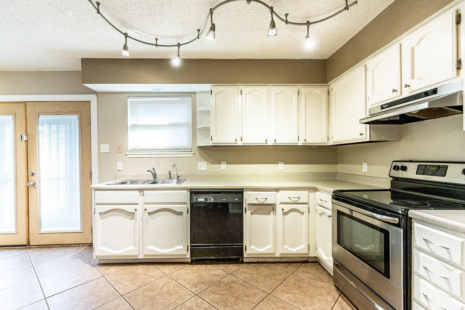4737 48th Street Lubbock, TX 79414 - Photo 14 of 34 a kitchen with stainless steel appliances granite countertop a sink and cabinets