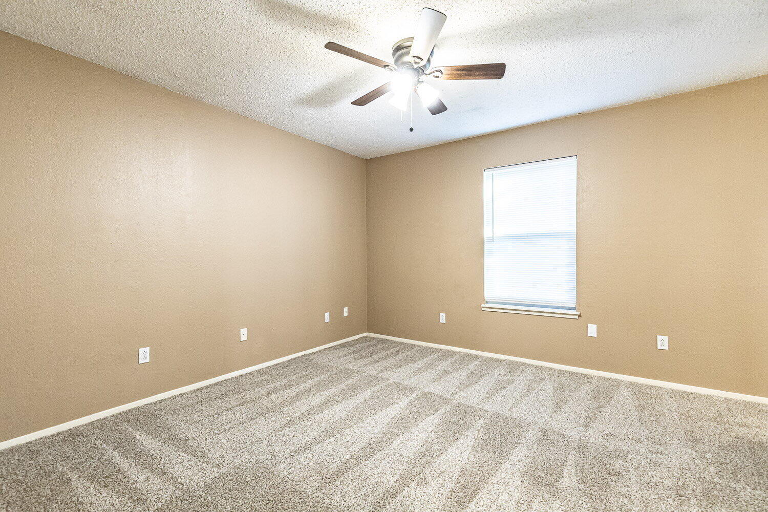 4737 48th Street Lubbock, TX 79414 - Photo 28 of 34 an empty room with windows and ceiling fan