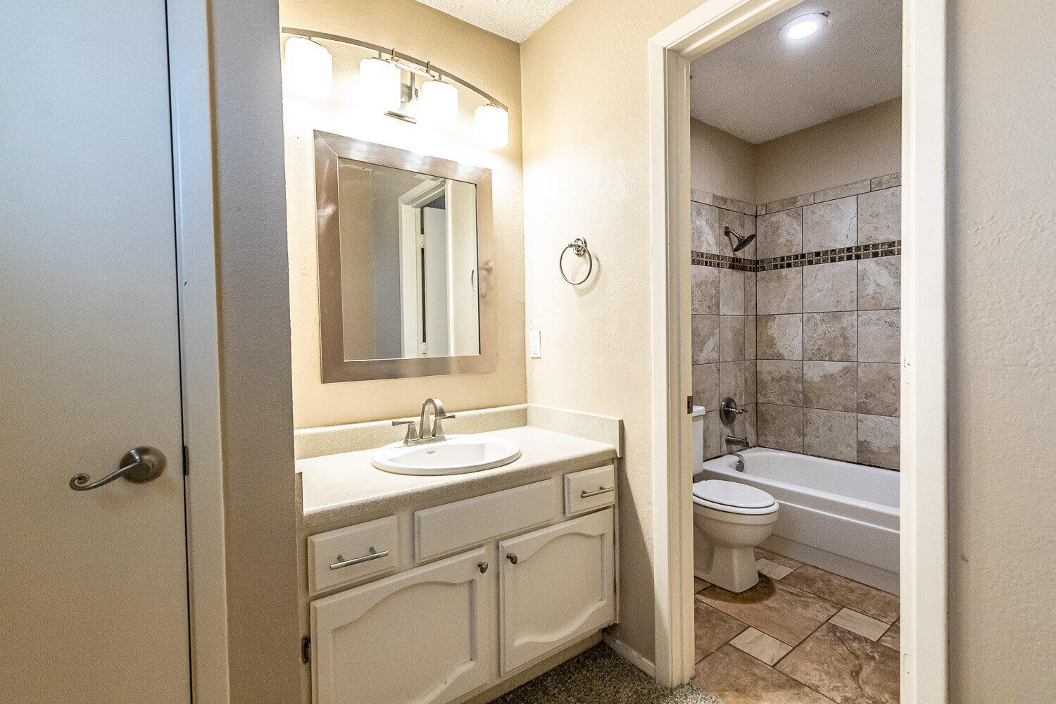 4737 48th Street Lubbock, TX 79414 - Photo 31 of 34 a bathroom with a double vanity sink toilet mirror and shower
